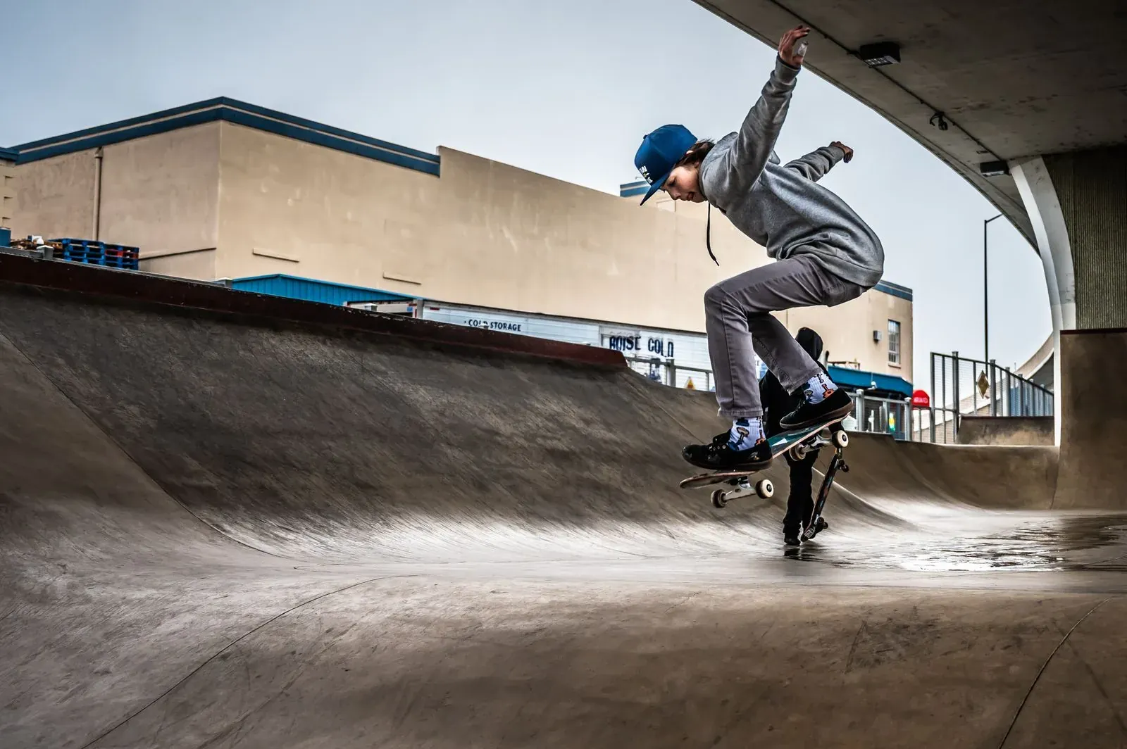 Skateboarder mid-trick in an urban plaza